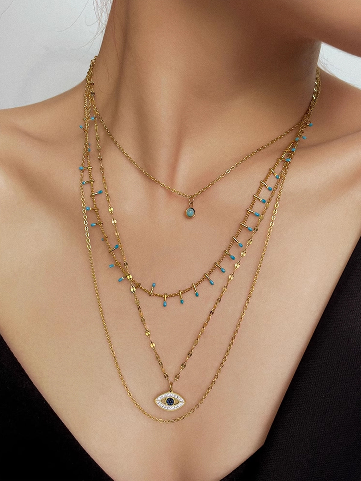 Collier pendentif œil maléfique en strass multicouches