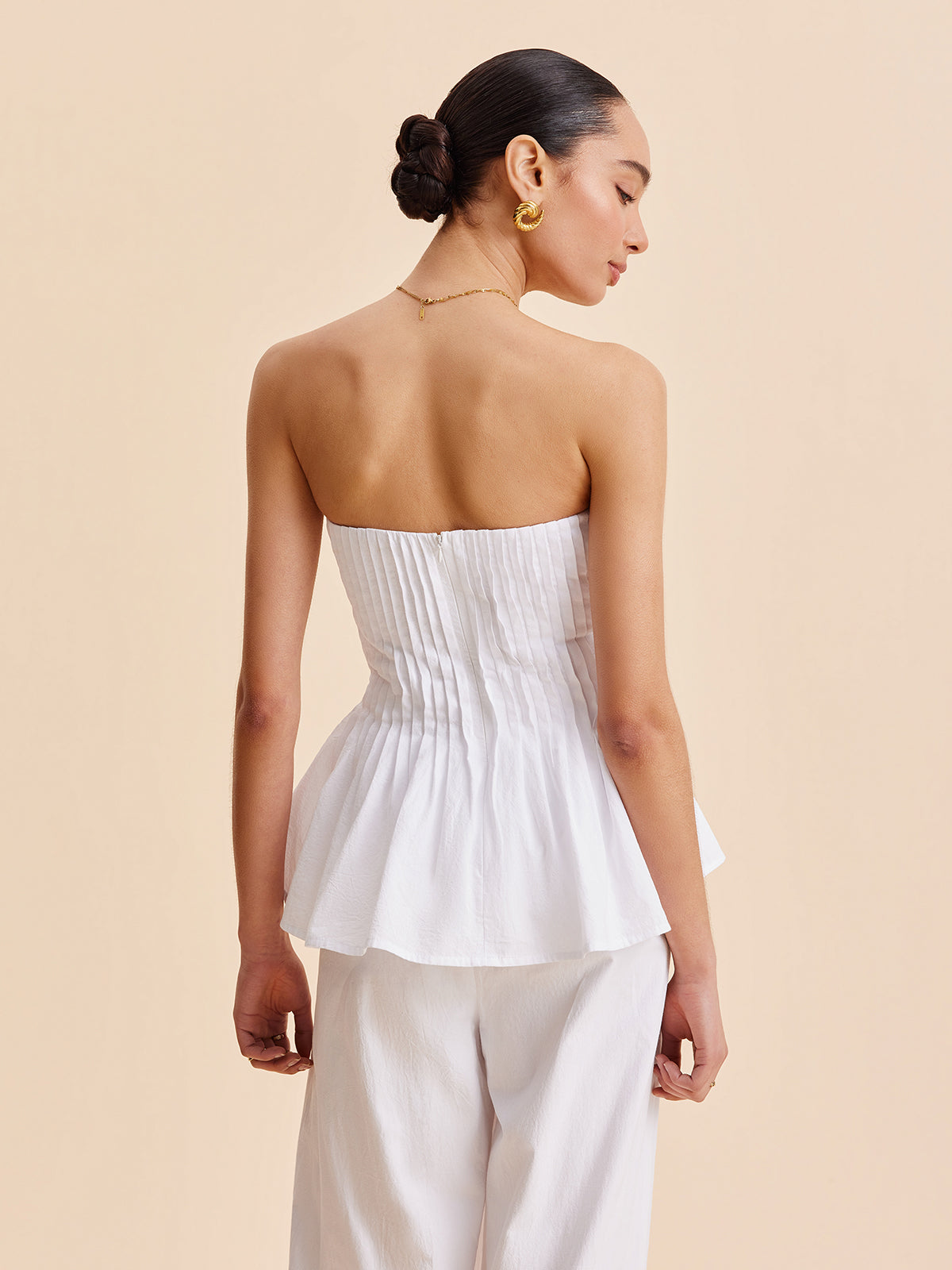 Gefaltetes trägerloses Peplum-Top aus Baumwolle