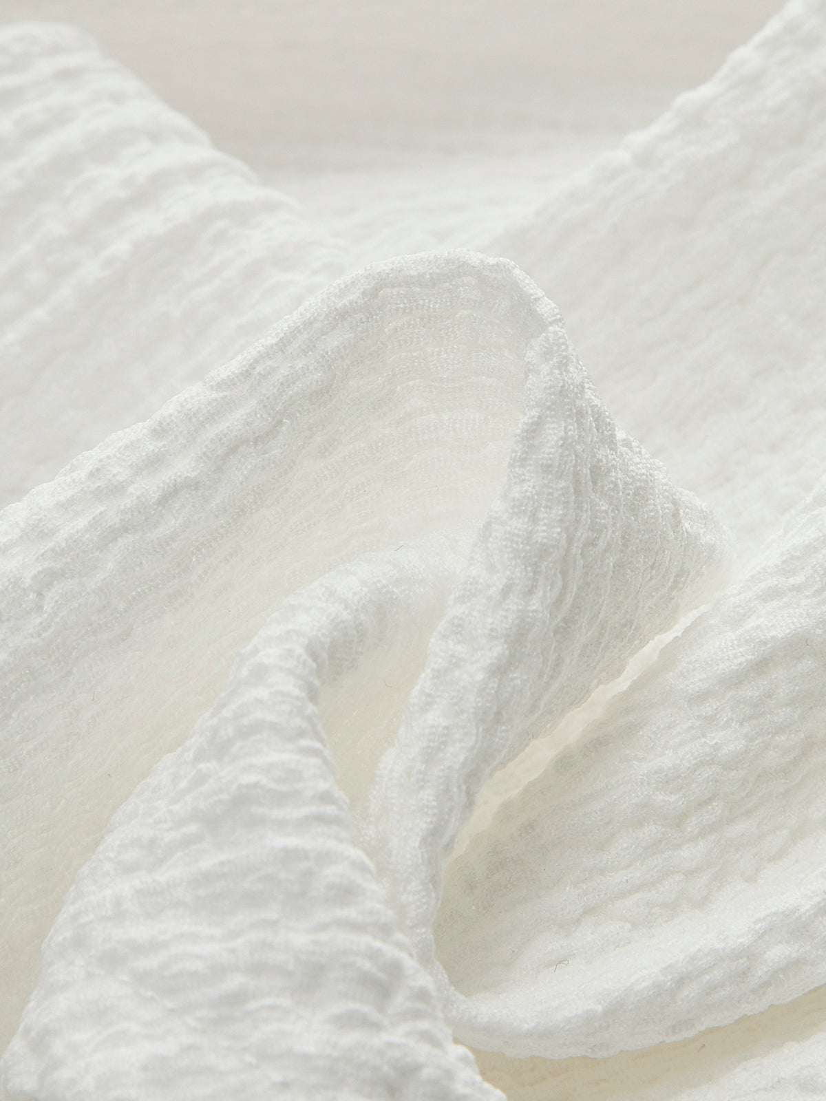 Haut à col en V et taille froncée orné d'un nœud