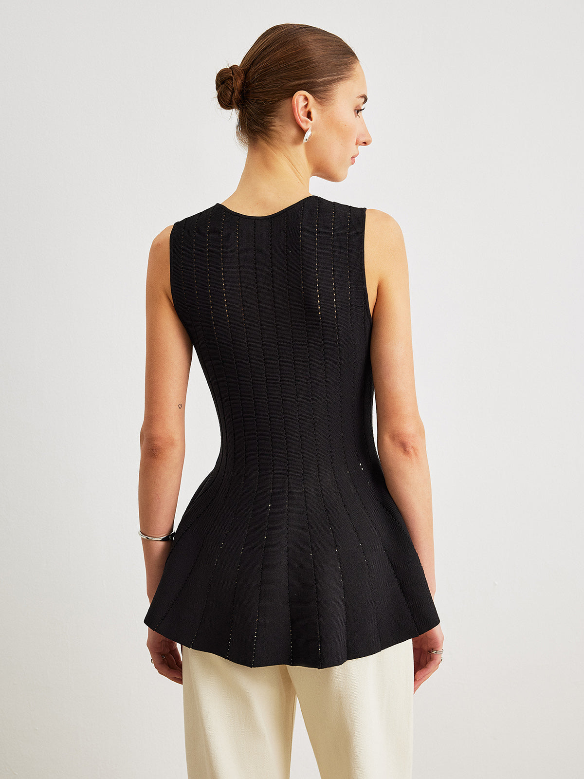 Haut péplum en maille semi-transparente avec nœud