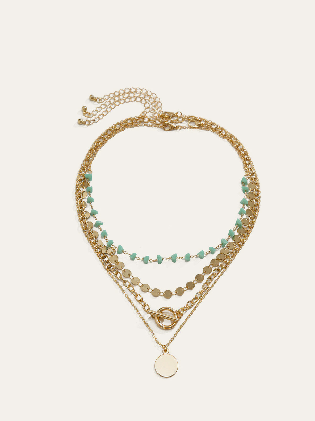 Collier multi-rangs chaîne dorée, perles turquoise et pendentif circulaire