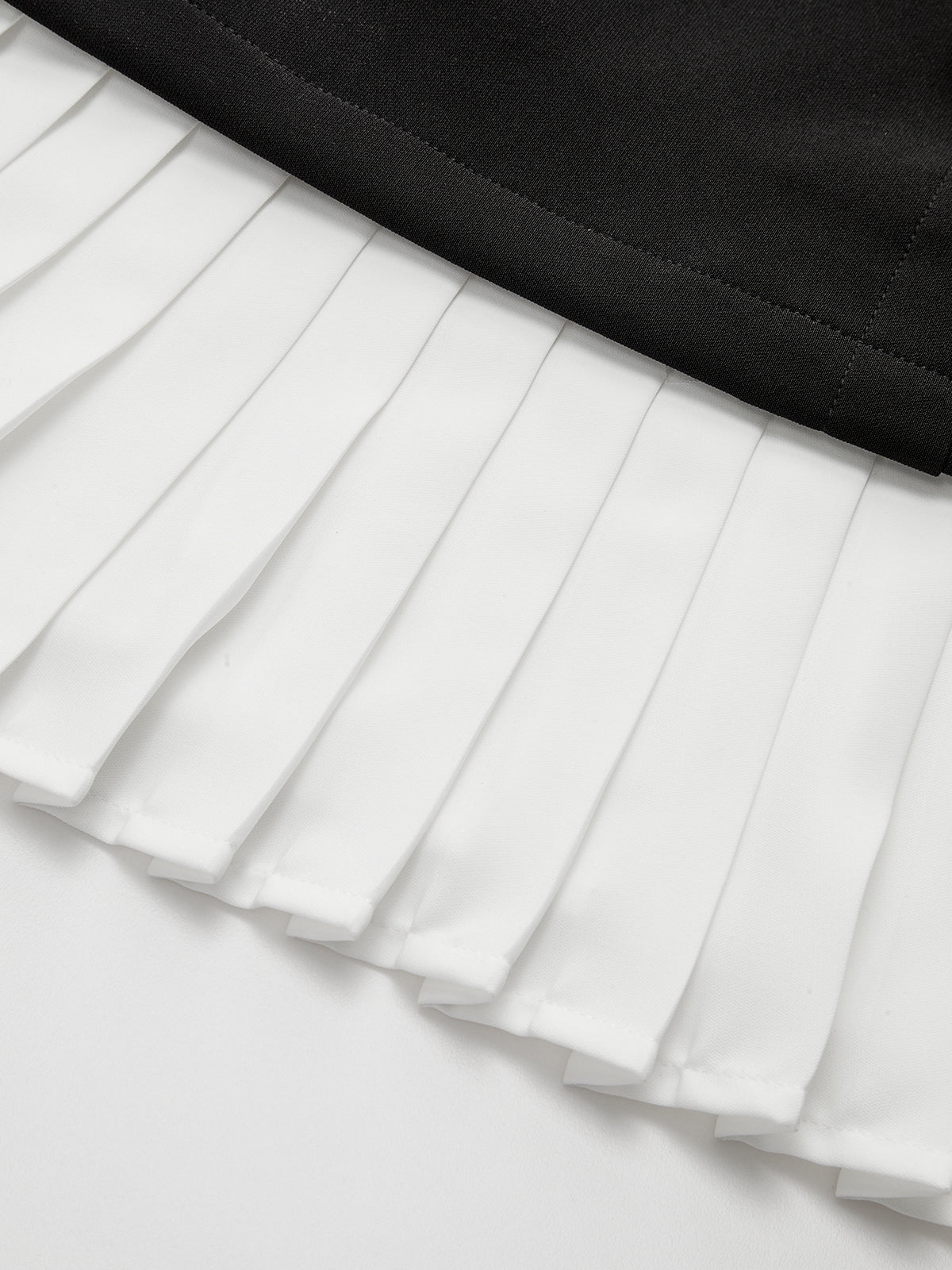 Mini-robe asymétrique à ourlet plissé et détails métalliques
