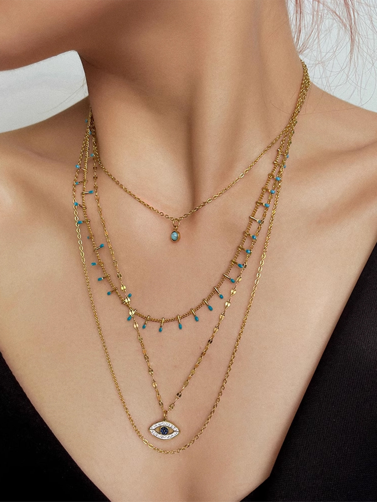 Collier pendentif œil maléfique en strass multicouches 