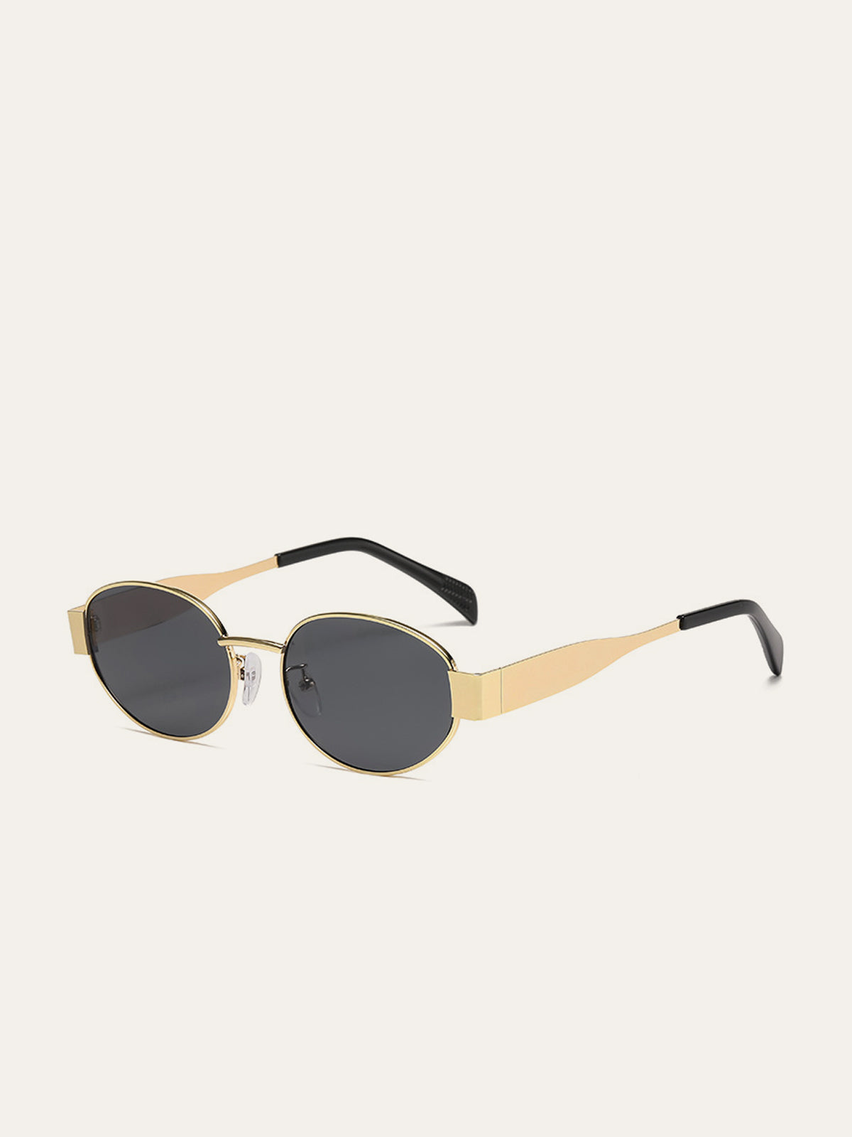 Lunettes de soleil ovales à monture dorée