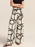 Pantalon ample semi-transparent à motifs