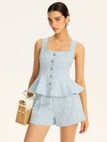 Gilet péplum en tissu texturé avec boutons métalliques