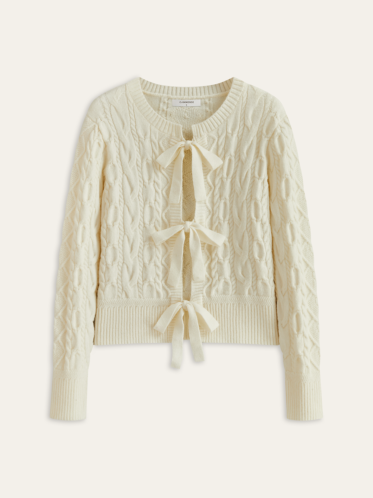 Cardigan en maille torsadée avec nœud papillon
