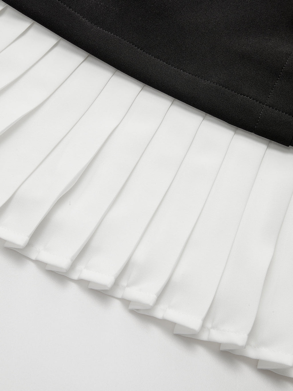 Mini-robe asymétrique à ourlet plissé et détails métalliques
