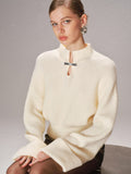 Pull en maille avec détail nœud en métal et manches à revers