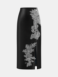 Jupe mi-longue fendue en similicuir brodée de motifs floraux