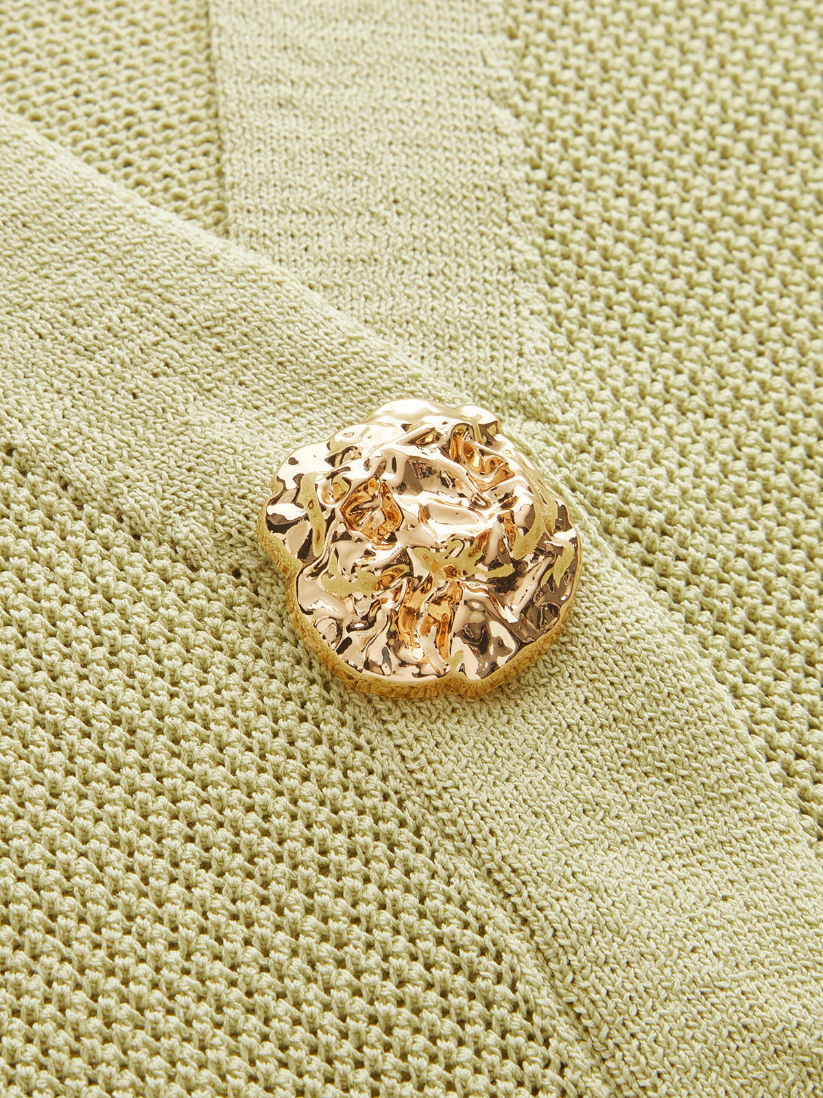 Gilet en tricot sans manches avec boutons en relief