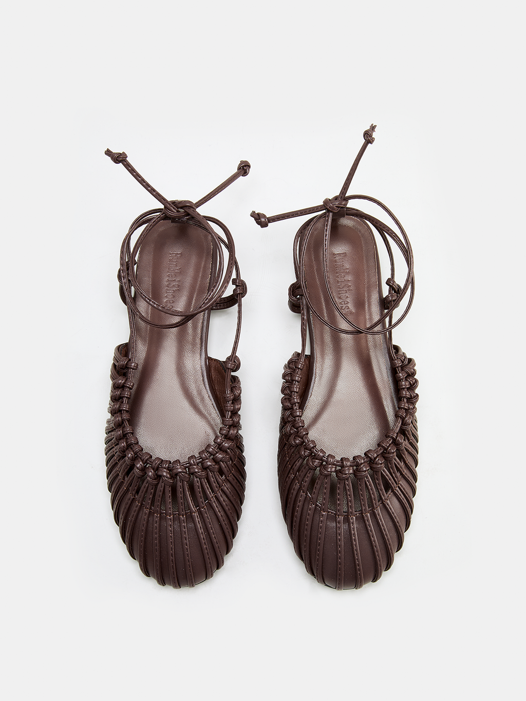 Sandales plates en cuir tressé à lacets