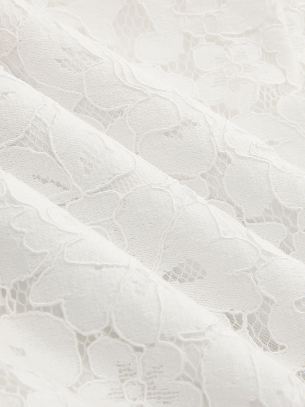 Mini-jupe asymétrique en dentelle et perles